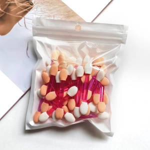 Detail of disposable dual-sided eyeshadow applicators with pink handles in clear packaging