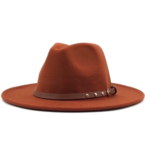 Detail of caramel wool fedora with brown faux leather band and metallic gold studs