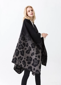Detailed close-up of knit leopard print shawl with grey gradient texture and finished edges