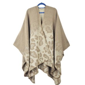 Close-up of leopard print pattern and soft knitted fabric texture of women's poncho