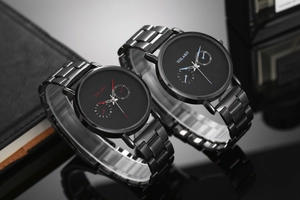 Close-up of sleek black stainless steel men's watches with vibrant red and blue pointers