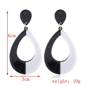 Macro detail of geometric teardrop earrings in black and white acrylic measuring 6cm