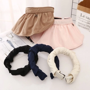 Minimalist shell-shaped sun visor hats and twist headbands in assorted solid colors