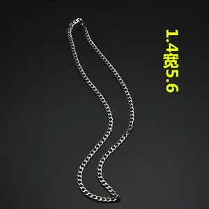 Detailed view of 1.4mm width silver stainless steel Cuban link chain on black background
