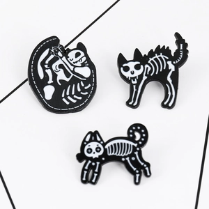 Detailed view of three punk skeleton cat enamel pins in black and white finish