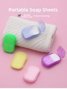 Five colorful portable travel soap paper boxes arranged next to a clean white towel