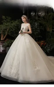 Detail of white princess wedding dress featuring exquisite lace embroidery and sequins