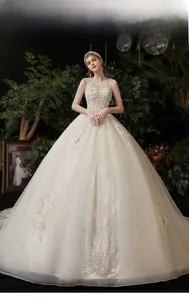 Detailed embroidery and sequins on ivory off-shoulder bridal gown with luxury tulle layers