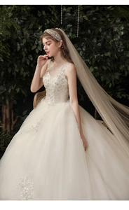 Close-up of luxury bridal gown with intricate lace embroidery and sparkling beadwork