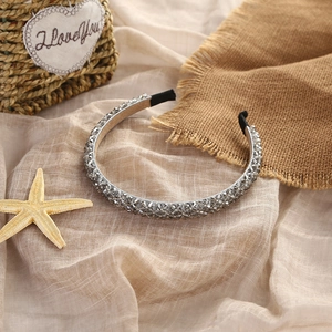 Elegant beaded crystal headband with silver grey rhinestones on soft beige fabric