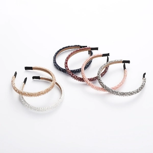 Detail view of six beaded crystal headbands in diverse colors with velvet lining