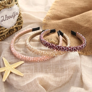 Detail of beaded crystal headbands in pink and champagne colors with soft padding