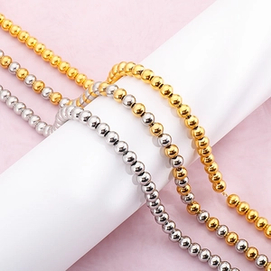 Three minimalist titanium steel beaded necklaces in gold, silver, and dual-tone finish