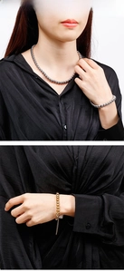 Polished titanium steel ball bead necklace and bracelet set shown on a black shirt