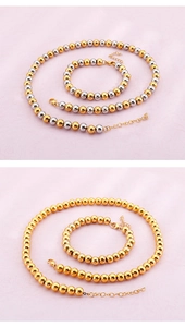 Detailed close-up of gold and silver beaded jewelry sets on soft pink fabric
