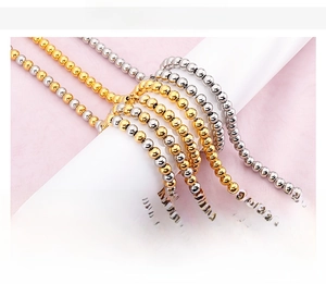 Detailed view of beaded stainless steel jewelry set in gold, silver, and two-tone finishes