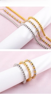 Detailed view of polished stainless steel round bead necklace and bracelet in multiple colors