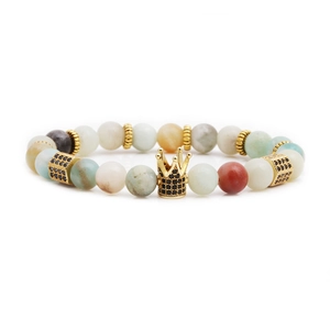 Beaded crown bracelet set with malachite and gold micro-pave charms on white background