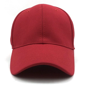 Detail of red baseball cap showing hexagonal mesh texture and breathable eyelets