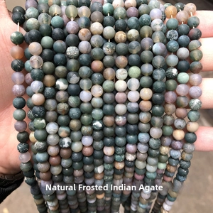 Macro shot of natural matte Indian Agate beads showing vintage textures and earthy tones