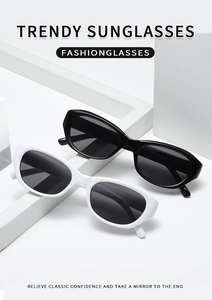 Détail de lunettes de soleil ovales rétro style minimaliste en noir et blanc