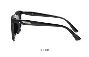 Side view of black resin sunglasses with silver metal bar accents and rivets on the temples