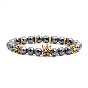 Hematite beaded bracelet featuring a gold crown charm and cubic zirconia accents