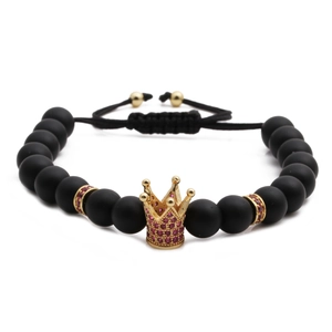 Frosted black stone braided bracelet with a golden crown charm and adjustable cord