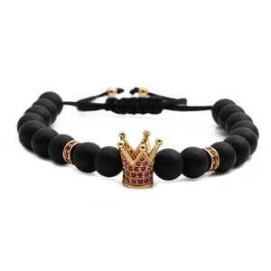 Adjustable woven bracelet with black matte beads and a golden crown charm featuring red gems