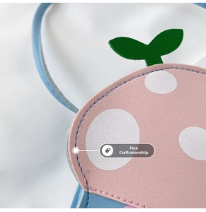 Close-up of pink and blue PU leather cartoon bag showing fine stitching detail