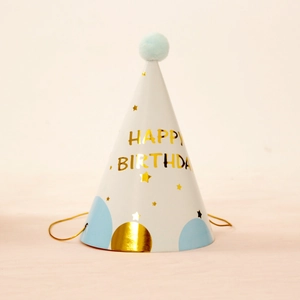 White birthday party hat with blue pom-pom, gold stars, and Happy Birthday text