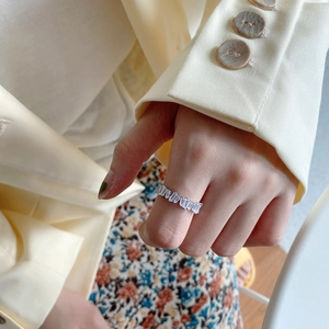 Detailed view of 925 silver ring with baguette-cut zircons worn on hand in French style