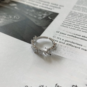 Macro shot of S925 silver ring featuring rectangular zircon stones and open band detail