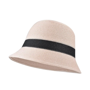Detailed view of women's straw bucket hat with black decorative band for summer.