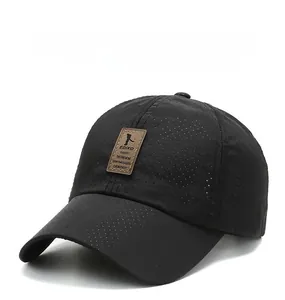 Detail of black breathable mesh baseball cap featuring a premium brown leather logo patch