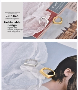 Close-up of minimalist geometric rectangular rings in gold and silver polished finish