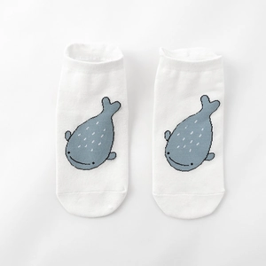 Detail shot of white cotton ankle socks featuring small blue embroidered whale patterns