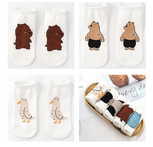 Detail of white cotton socks with cute cartoon animal patterns and cozy lifestyle presentation