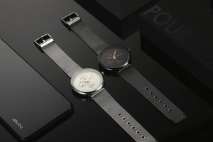 Detail of luxury men's watches with blue hands and mesh metal strap on reflective surface