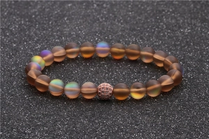 Frosted moonstone beads bracelet with a rose gold zircon pave ball on dark background