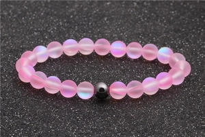 Handmade 8mm moonstone and hematite beaded bracelet with pink matte beads on black background
