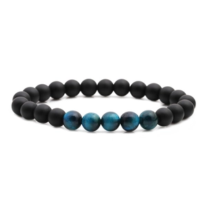 Detailed view of matte black onyx beads and blue tiger eye stones on a stretch bracelet