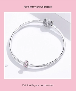 Detail of S925 silver snake chain bracelet featuring pink enamel flower and cat clasp