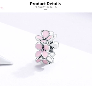 Macro shot of S925 sterling silver flower charm with delicate pink enamel petals