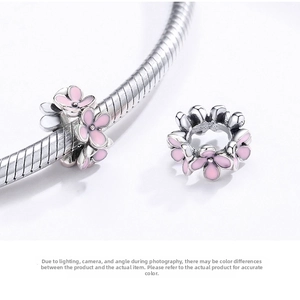Macro shot of 925 silver charm with pink enamel flowers for bead bracelets