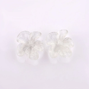 Detailed macro view of two clear resin 3D flower pendants with intricate petal textures