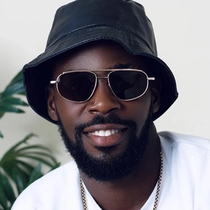 Modern double bridge aviator sunglasses with gold metal frame worn by a model with a black hat