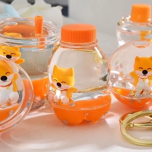 Creative oil-infused acrylic soda bottle keychain with an orange fox doll and golden clasp