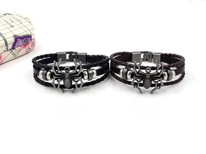 Detail of vintage punk leather bracelets with large silver spider charms and metal studs