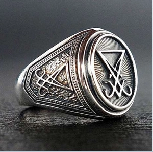 Macro shot of gothic Sigil of Lucifer ring showing intricate vintage silver engraving detail